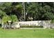 Entrance sign for Mission Lakes community with manicured landscaping and a tropical tree at 330 Mission N Trl # F, Venice, FL 34285
