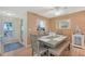 Cozy dining area featuring beach decor and view to kitchen, perfect for Gathering meals at 330 Mission N Trl # F, Venice, FL 34285