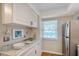 Bright kitchen featuring white cabinets, countertops, stainless steel appliances and beach themed decor at 330 Mission N Trl # F, Venice, FL 34285