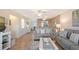 The living room features stylish sofas, a ceiling fan and hardwood flooring at 330 Mission N Trl # F, Venice, FL 34285