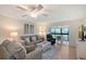 Inviting living room features comfortable seating, a ceiling fan, and seamless access to a bright sunroom at 330 Mission N Trl # F, Venice, FL 34285
