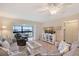 The living room features stylish decor, wood flooring and a lovely view of the outdoors at 330 Mission N Trl # F, Venice, FL 34285