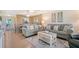 The living room features stylish sofas, a ceiling fan and seamless access to the dinning area at 330 Mission N Trl # F, Venice, FL 34285