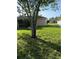 Large grassy backyard with mature trees near house at 3601 Point St, North Port, FL 34286