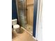 Cozy bathroom featuring a step-in shower with glass door and neutral tiled flooring at 3601 Point St, North Port, FL 34286