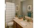 Cozy bathroom with a toilet, shower/tub combo, large mirror and stylish decor at 3601 Point St, North Port, FL 34286