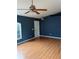 Spacious living room with beautiful hardwood floors, stylish ceiling fan, and ample light at 3601 Point St, North Port, FL 34286