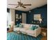 Inviting living room with stylish blue walls, plush sofa, and elegant decor at 3601 Point St, North Port, FL 34286