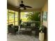 Bright sunroom featuring comfortable seating, ceiling fan, and views of the lush yard at 3601 Point St, North Port, FL 34286