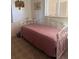 Bedroom with carpet and a twin bed with a pink coverlet at 3697 Lake Bayshore Dr # H-109, Bradenton, FL 34205