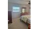 Bedroom features a bed, carpet, dresser, and a view of the water from the window at 3697 Lake Bayshore Dr # H-109, Bradenton, FL 34205