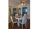 Bright dining area featuring a glass-top table with seating for four and decorative mirror accents at 3697 Lake Bayshore Dr # H-109, Bradenton, FL 34205
