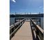 Dock on the lake with bench seating under canvas sunshades at 3697 Lake Bayshore Dr # H-109, Bradenton, FL 34205