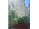 Beige condo building featuring well maintained landscaping with tropical palm trees and partial blue skies at 3697 Lake Bayshore Dr # H-109, Bradenton, FL 34205