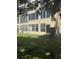 Exterior view of the well-maintained building with large windows and lush lawn at 3697 Lake Bayshore Dr # H-109, Bradenton, FL 34205