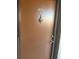 Condo unit featuring brown front door, door knob and address number 3697 with a bronze door knocker at 3697 Lake Bayshore Dr # H-109, Bradenton, FL 34205