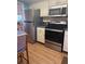 Updated kitchen with stainless steel appliances including a refrigerator, oven, and microwave at 3697 Lake Bayshore Dr # H-109, Bradenton, FL 34205