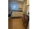 Cozy kitchen with wood floors, white cabinets, a kitchen sink, and seating at the breakfast bar at 3697 Lake Bayshore Dr # H-109, Bradenton, FL 34205