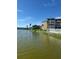 Scenic waterfront view with lush landscaping and multi-story condo buildings at 3697 Lake Bayshore Dr # H-109, Bradenton, FL 34205