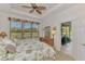 Bedroom with a tropical ceiling fan and beautiful green views at 371 Capulet Dr, Venice, FL 34292