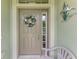 Inviting front door with a decorative wreath and a Heron decoration on the wall at 371 Capulet Dr, Venice, FL 34292
