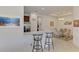 Kitchen featuring a breakfast bar, stainless steel appliances, and an adjacent dining area at 371 Capulet Dr, Venice, FL 34292