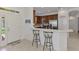 Kitchen view featuring a breakfast bar, stainless steel appliances, and white cabinetry at 371 Capulet Dr, Venice, FL 34292