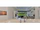 Kitchen featuring modern appliances and a view of the comfortable living room and patio at 371 Capulet Dr, Venice, FL 34292