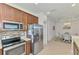 Kitchen features stainless appliances and adjacent dining area at 371 Capulet Dr, Venice, FL 34292