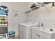 Laundry room equipped with a washer, dryer, sink, and shelving at 371 Capulet Dr, Venice, FL 34292