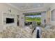 Inviting living room with stylish coastal decor, tile floors, and serene lake views at 371 Capulet Dr, Venice, FL 34292