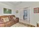Cozy living room with comfortable seating and access to the bathroom with shower at 371 Capulet Dr, Venice, FL 34292