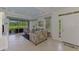 Bright living room with neutral tile flooring and a view of the outdoor patio at 371 Capulet Dr, Venice, FL 34292