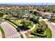 Aerial view of a neighborhood with a playground, lush green spaces, and manicured landscaping at 371 Capulet Dr, Venice, FL 34292