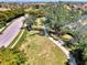 Aerial view of a neighborhood park, with a walking path, benches, and mature landscaping at 371 Capulet Dr, Venice, FL 34292