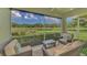 Relaxing screened patio with comfortable seating and a scenic lake view at 371 Capulet Dr, Venice, FL 34292