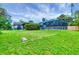 Spacious backyard showcasing a pool with a screened enclosure and lush landscaping at 386 Nightingale Rd, Venice, FL 34293