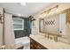 Charming bathroom with a combined tub and shower, decorative vanity, and tasteful decor at 386 Nightingale Rd, Venice, FL 34293