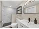 Modern bathroom with a walk-in shower, sleek vanity, and stylish black and white accents at 386 Nightingale Rd, Venice, FL 34293