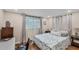 Bedroom with a large window with natural light, hardwood floors, and neutral decor at 386 Nightingale Rd, Venice, FL 34293