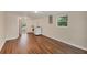 Large bonus room with hardwood floors and a laundry area with modern appliances at 386 Nightingale Rd, Venice, FL 34293