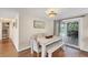 Cozy dining area with a white table, chairs, bench and sliding glass doors to outdoor patio at 386 Nightingale Rd, Venice, FL 34293