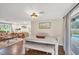 Open concept dining room with an adjacent living room and access to the pool area at 386 Nightingale Rd, Venice, FL 34293