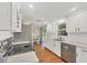 Bright kitchen featuring white cabinets, stainless steel appliances, and a window over the sink at 386 Nightingale Rd, Venice, FL 34293
