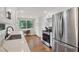 Updated kitchen with stainless steel appliances, white cabinets, and bright natural light, blending style and functionality at 386 Nightingale Rd, Venice, FL 34293