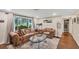 Bright living room with large windows, comfortable furniture, and stylish accents, perfect for relaxation and entertaining at 386 Nightingale Rd, Venice, FL 34293