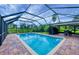 Beautiful in-ground pool with screened enclosure offering both a sunning and shaded sitting area at 386 Nightingale Rd, Venice, FL 34293