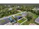 Aerial view of the property with the surrounding neighborhood and lush greenery, solar panels, and pool at 4033 Union Ln, North Port, FL 34288
