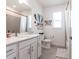 Bathroom features white vanity with a gray tile shower and a window at 4033 Union Ln, North Port, FL 34288