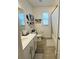 Neutral bathroom features shower-tub combo, elongated toilet, and vanity at 4033 Union Ln, North Port, FL 34288